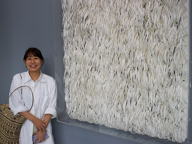 Artist Mia Liu 劉文瑄 in front of a work from her 2022 series 