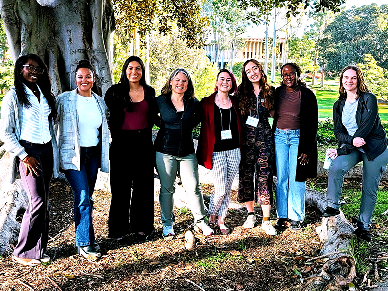 Members of the RESSLab and the Biology Department pose in front of a tree at the 10th annual Society for the Advancement of Biology Education Research conference (from left to right: Amarachi Onyewuenyi, Olivia Williams, Morgan Ventura, Christelle Sabatier, Desirée Forsythe, Jazmine Low, Tiffany Kinyua, Michelle Badura)