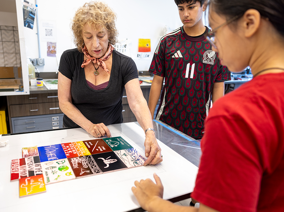 Lecturer Kathryn Kain guides a linocut printing activity at the Ohlone Cultural Camp.