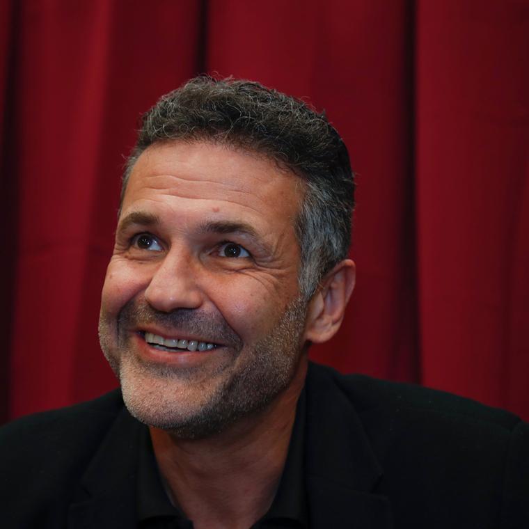 Khaled Hosseini smiling image link to story