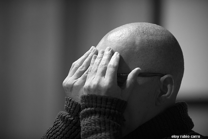 Juan Velasco with his hands covering his eyes.