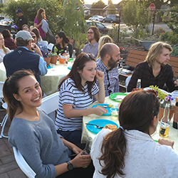 People dining and conversing at an outdoor event.
