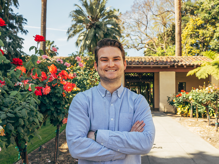 Henry Furguson standing next to rose bushes. image link to story