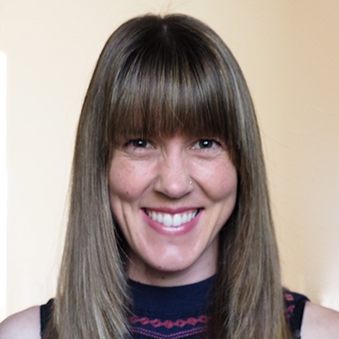 A woman smiling, wearing a sleeveless top with stripes. image link to story