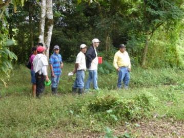 Group of people standing in a forest clearing.