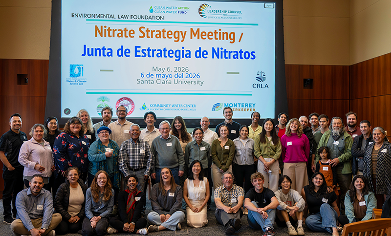 A group of attendees in front of projection of Nitrate Strategy Meeting presentation title
