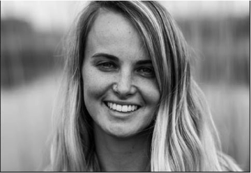 Smiling person named Colleen in a black-and-white photo. image link to story