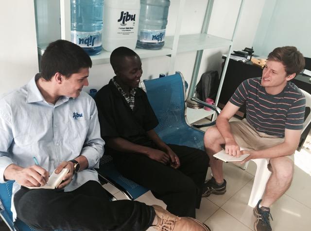 Three people sitting and talking in a bright room. image link to story