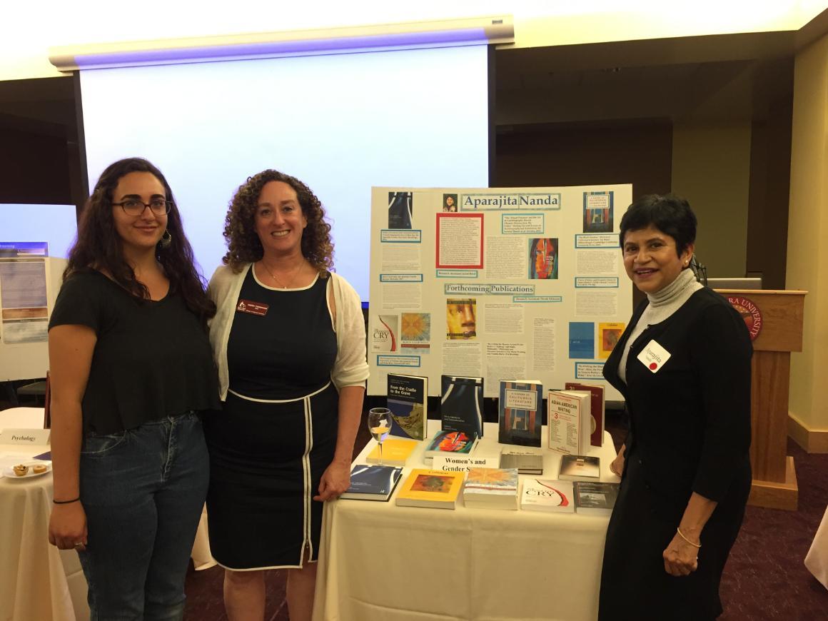 Three people standing next to a research display board. image link to story