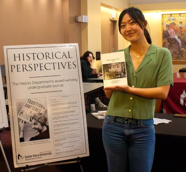 A student holding a copy of Historical Perspectives