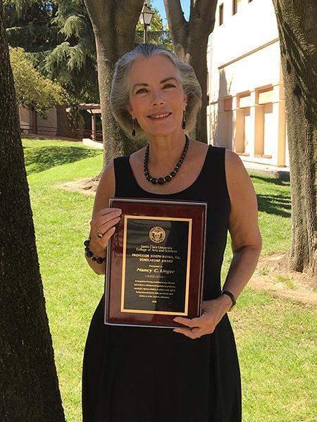Nancy Unger holding award