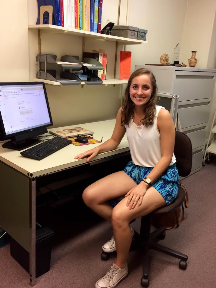 A woman sitting at a desk with a computer.