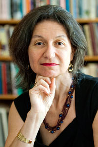 A person posing in front of a bookshelf. image link to story