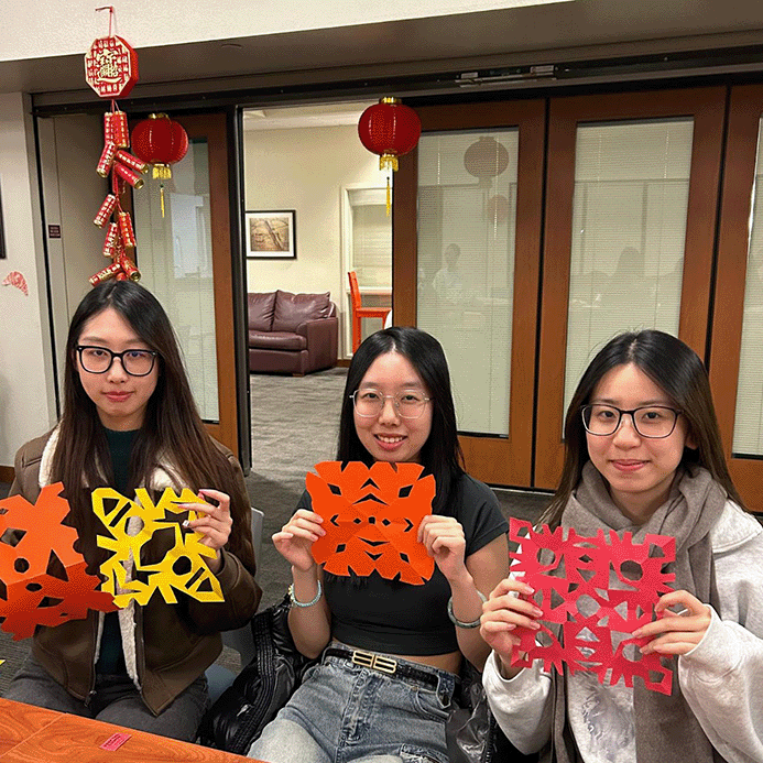 Students with their cut art work during the 2024 Lunar New Year celebration image link to story