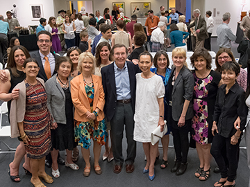 A large group of people posing for a photo at an event. image link to story