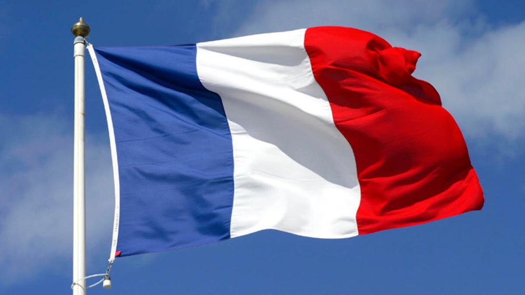 French flag waving against a blue sky image link to story