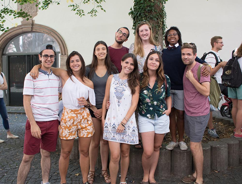 A group of people posing outdoors in front of a building. image link to story