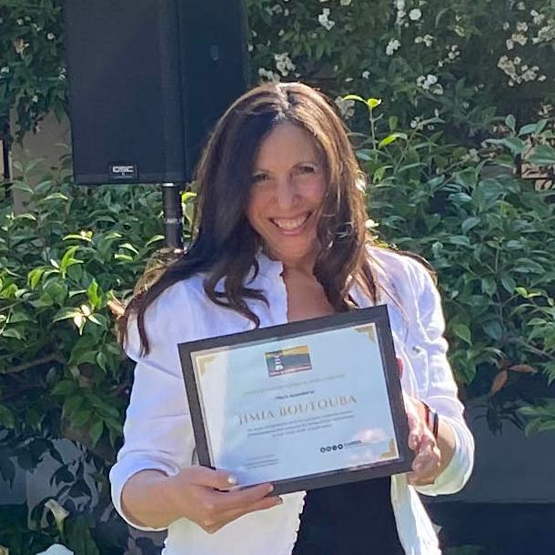 Jimia Boutouba holding her SCU Career Center award for Outstanding Career Influencer. image link to story