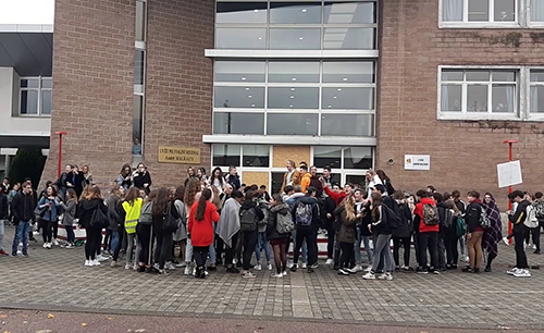 Group in front of school entrance