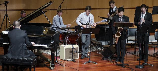 Jazz combo performing on stage with piano 