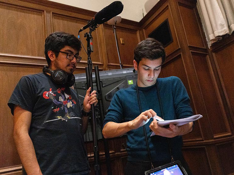 Evan Fine and assistant holding filming microphone