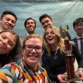 2023 Ethics Bowl team with trophy.