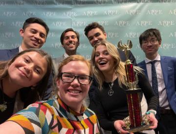 2023 Ethics Bowl team with trophy. image link to story