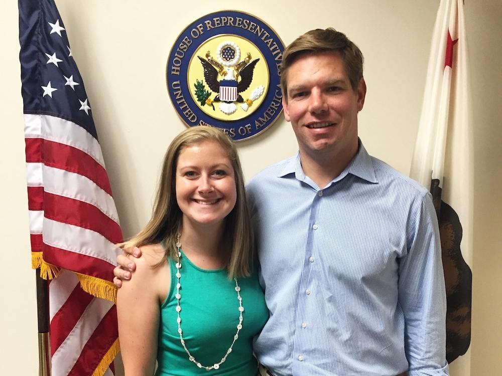 Two individuals posing in front of American and Illinois state flags. image link to story