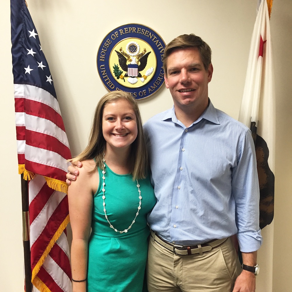 Two individuals posing in front of American and Illinois state flags. image link to story