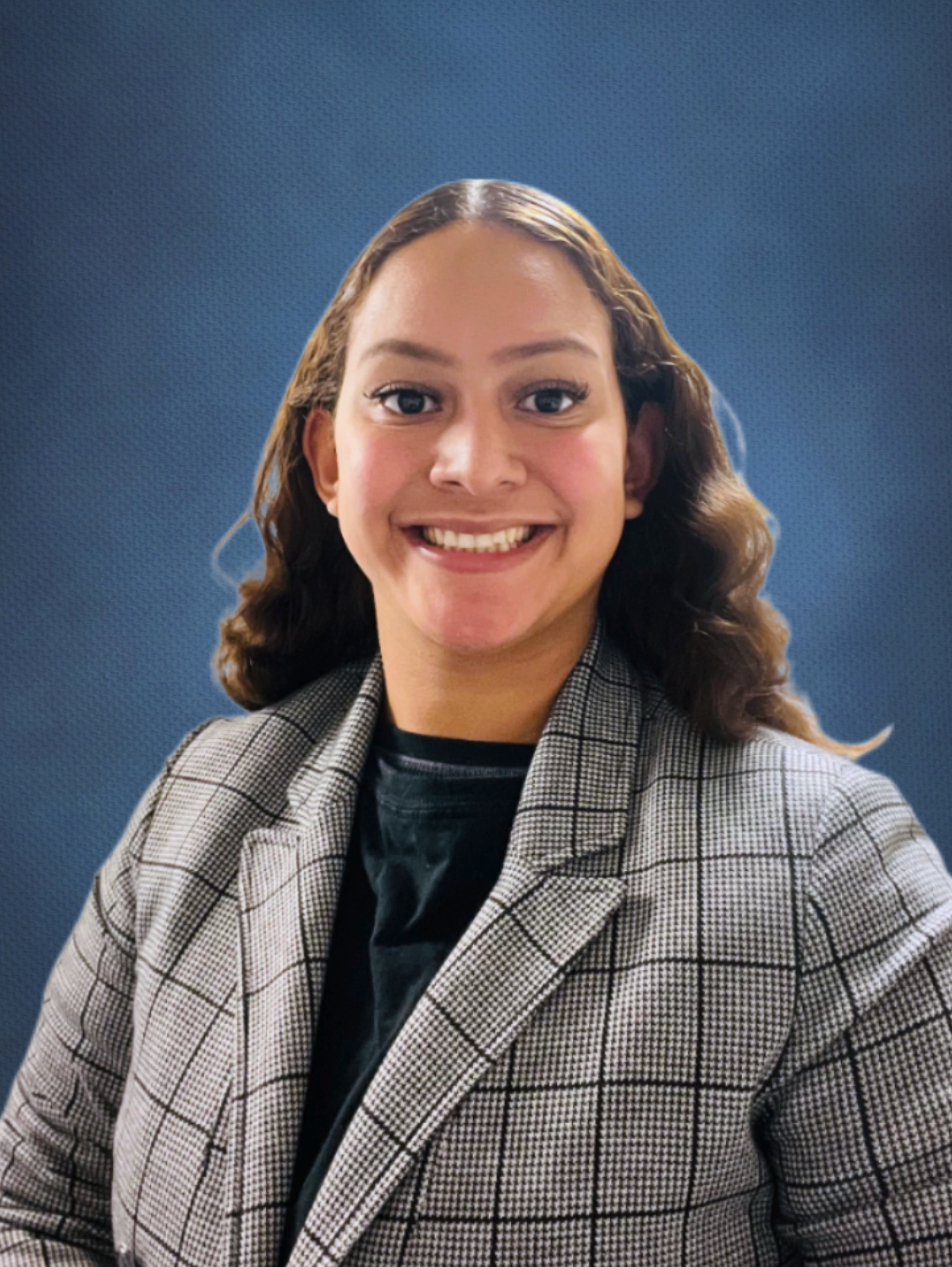 A person smiling, dressed in a gray checkered blazer. 