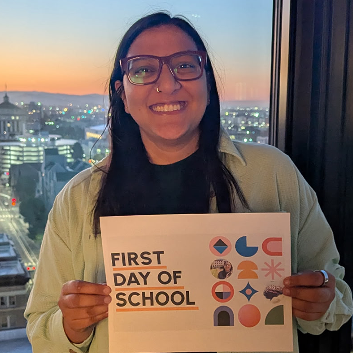 Tanya Gupta holding a note saying First Day of School