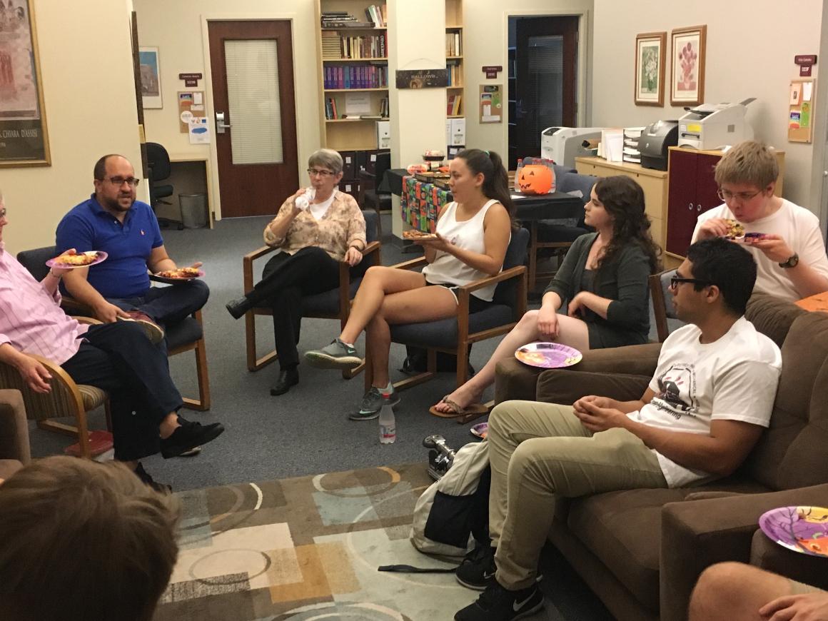 A group discussion on Religion and Natural Disasters in a room.