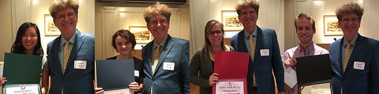 People posing and smiling at a 2017 awards event.