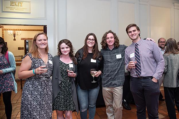 A group of people smiling at a reception event.