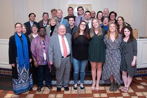 Group of people posing together at a reception.