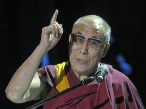 The Dalai Lama speaking while pointing his finger upward. image link to story