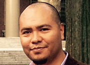 A person in a formal setting, wearing a suit. image link to story