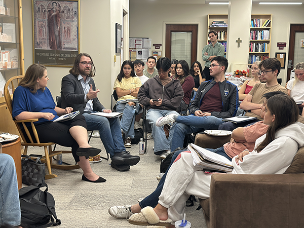 Students sitting in the RS lobby and engaged in conversation led by Nicholas Hayes-Mota..