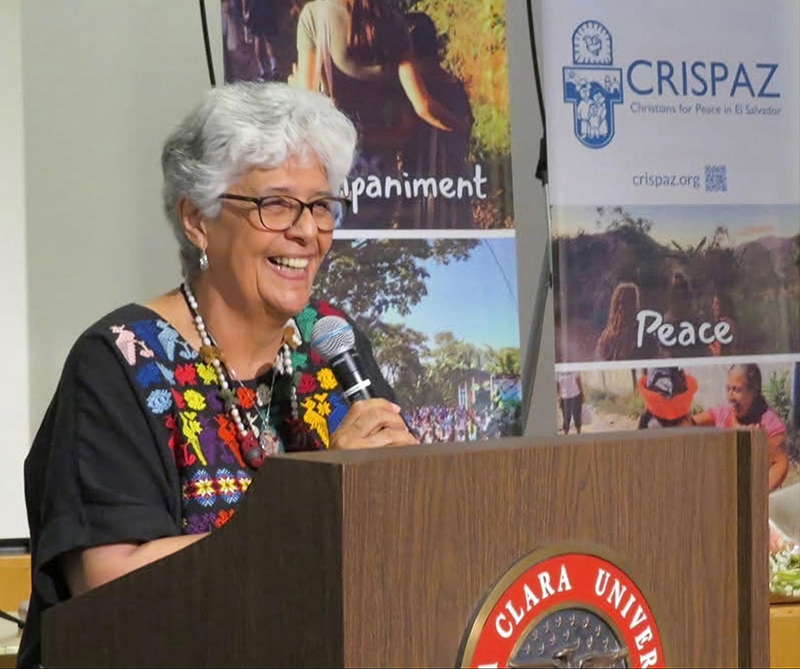 Ana María Pineda at the podium giving an acceptance speech for the CRISPAZ Peter Hinde Peace Award