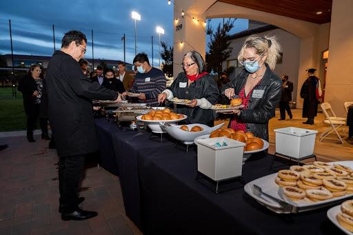 people getting food from buffet line