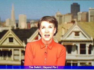 A person named Sally speaking with Victorian houses in the background. image link to story