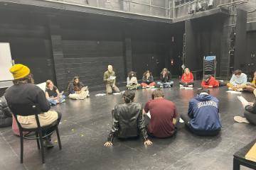 Students on the Fess Parker Stage reading text for 