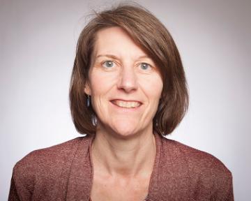 Alt text: Woman smiling for a portrait. image link to story