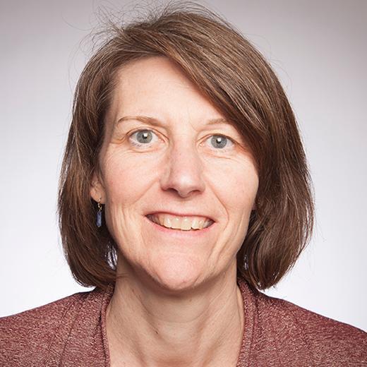 Alt text: Woman smiling for a portrait.