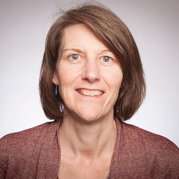 Alt text: Woman smiling for a portrait.