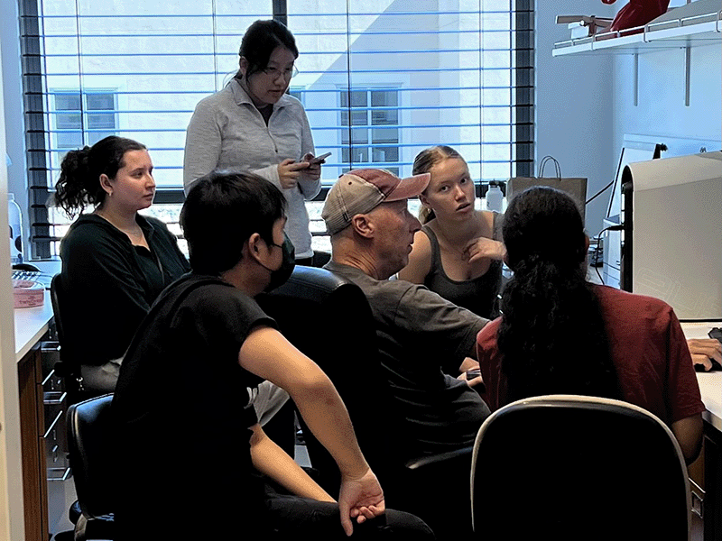 Professor Craig Stephens and students in lab. image link to story