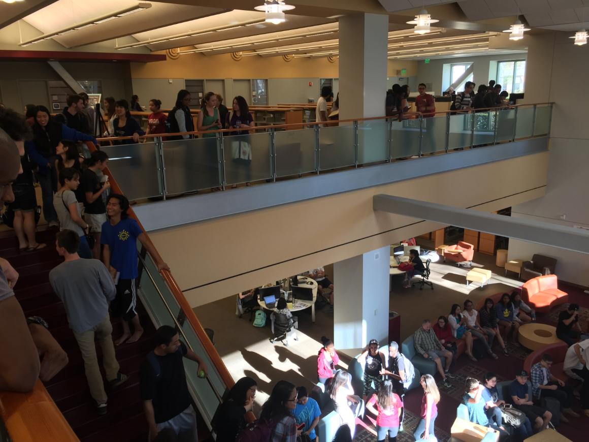 Students gather in a multi-level library during a study break. image link to story