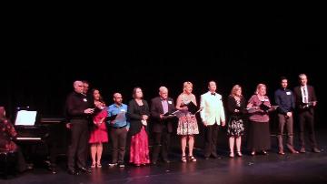 The cast of Fred standing in a line on stage.