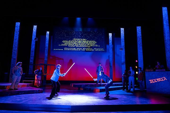 Scene from Shakespeare's Twelfth Night set in a 1970s nightclub. 2 actors duel with lightsabers