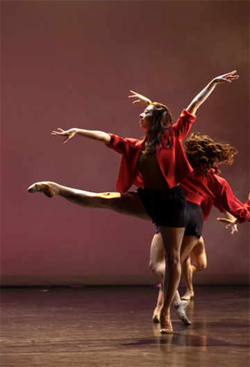 Dancers in red shirts and black biketards